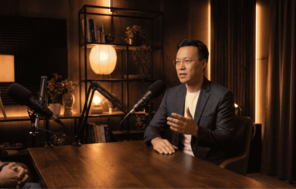 Allen Cheng Toronto Realtor discussing Toronto residential and commercial real estate market trends on podcast studio